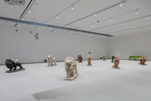 Lion sculptures in a gallery space.
