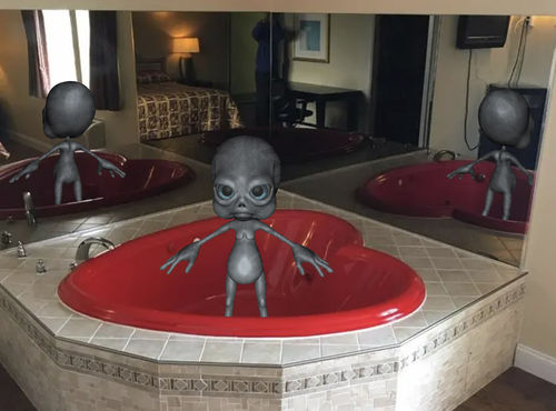 Alien in a bath tub shaped like a heart.
