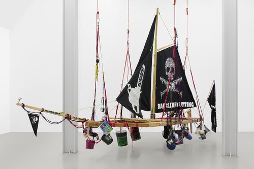A pirate ship with various buckets and objects attached to it.