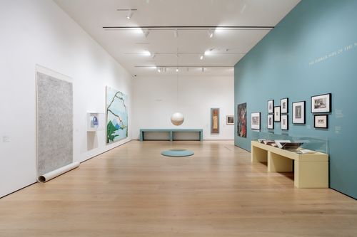 View of a gallery with artworks in a variety of media