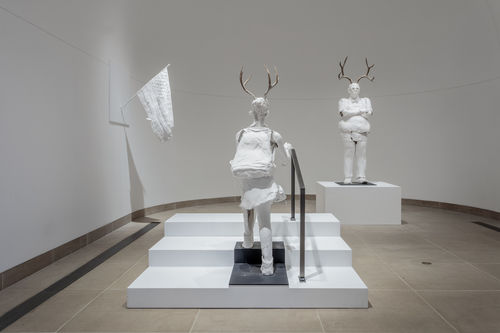 Sculptures of plastered white humanoids with horns. Occupying classic gallery space