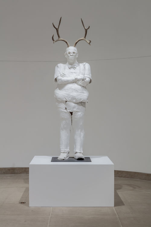 Sculptures of plastered white humanoids with horns. Occupying classic gallery space
