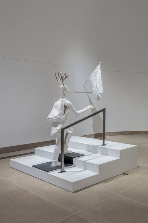 Sculptures of plastered white humanoids with horns. Occupying classic gallery space