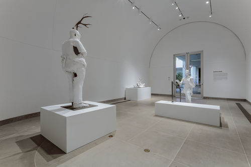 Sculptures of plastered white humanoids with horns. Occupying classic gallery space