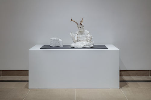 Sculptures of plastered white humanoids with horns. Occupying classic gallery space