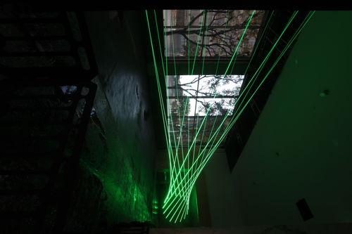 Green lasers fill a room