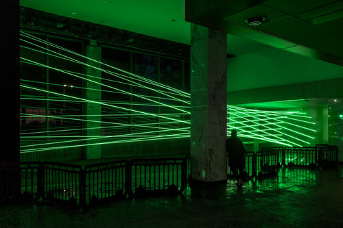 Green lasers fill a room