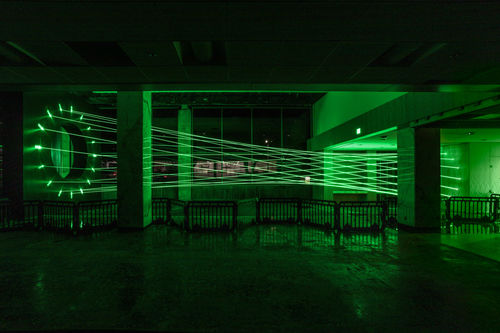 Green lasers fill a room