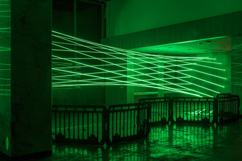 Green lasers fill a room