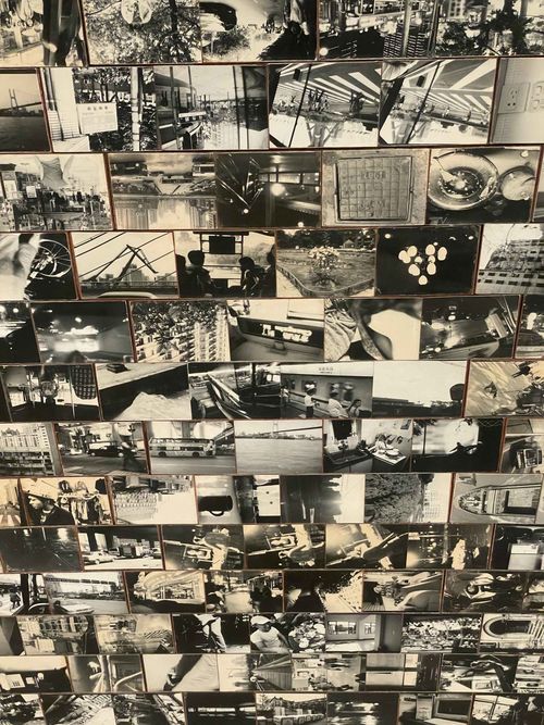 Installation on floor of black and white photographs