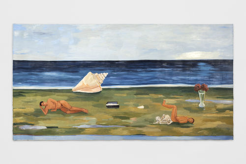 people lay on a grassy beach with sail boat in the background