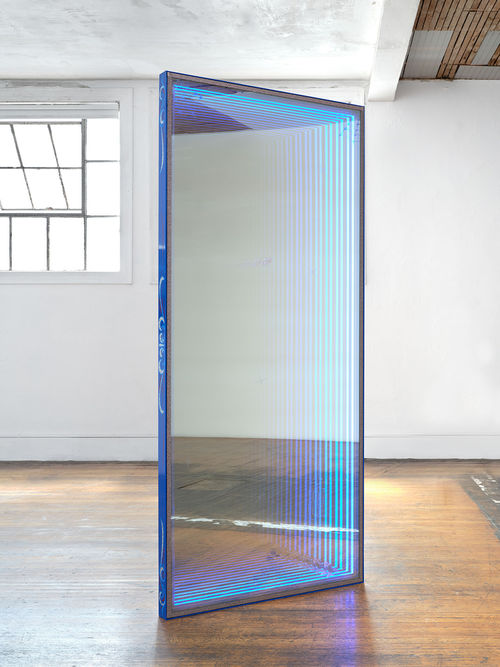 Blue door with lighting around the edges has a fantasy mirror like quality