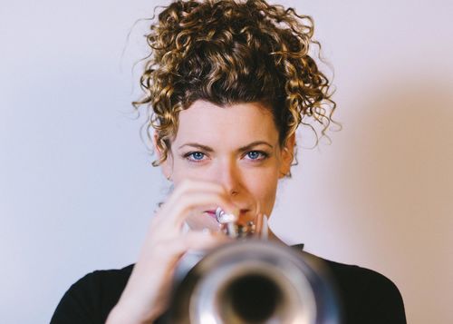 A woman holding a trumpet