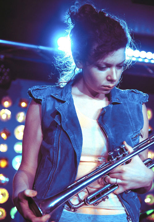 A woman holding a trumpet