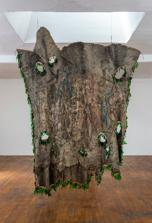 Large hanging artwork made from found materials