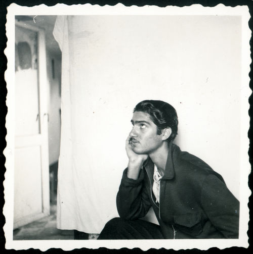 Photo portrait of photographer Van Leo looking out the window