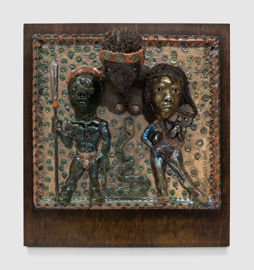 Dimensional sculpture with three figures in African garb