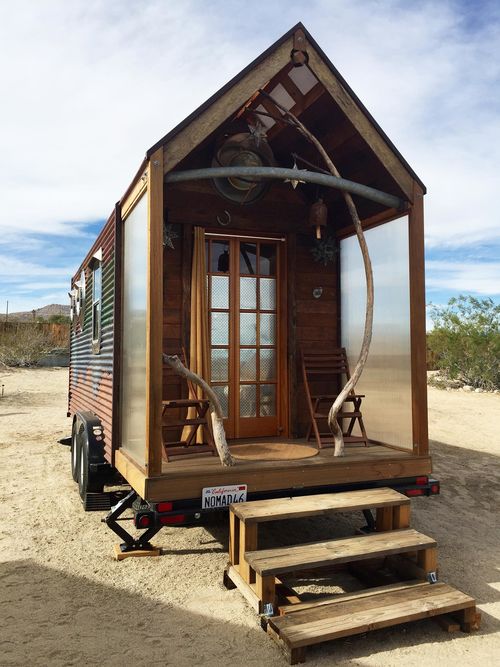 View of a mobile cabin with a small wood porch