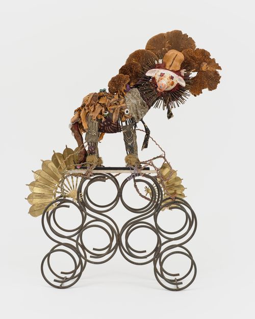 Assemblage sculpture featuring a lion toy