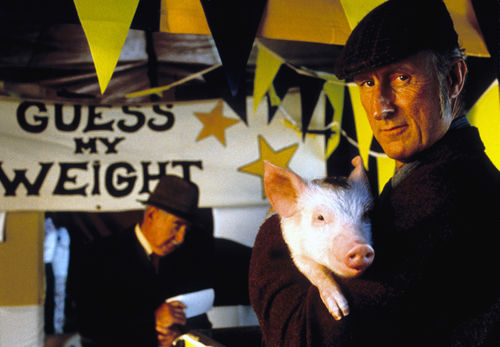 Actor James Cromwell holding Babe the pig