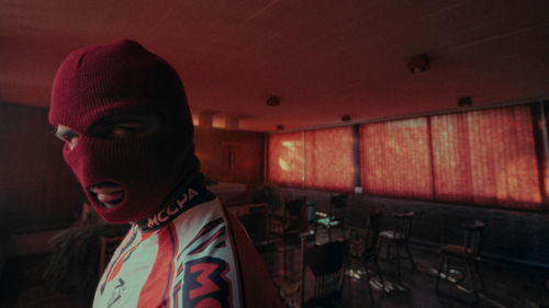 Still of a person wearing a red ski mask
