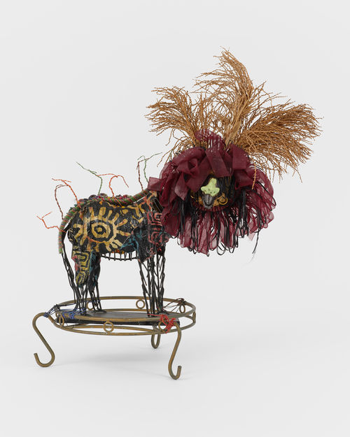 Assemblage sculpture featuring a lion toy