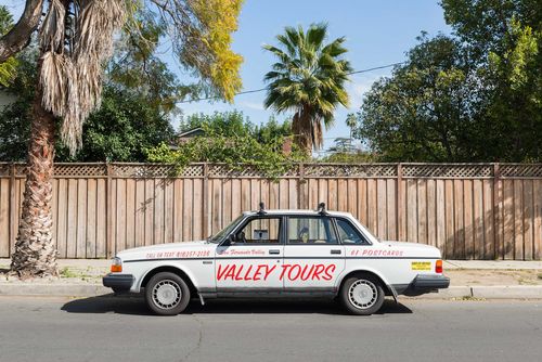Photo of a tan car with "VALLEY TOURS" painted on the doors