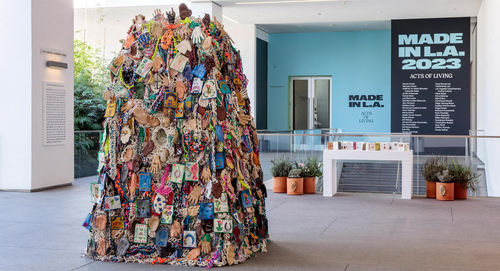 Large-scale sculpture covered in ceramic hands
