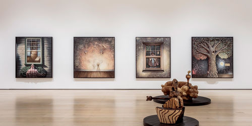 Gallery view with a wall of four paintings