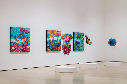 View of a gallery full of colorful artworks