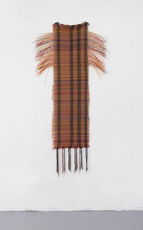 Mixed-media assemblage hanging on the wall