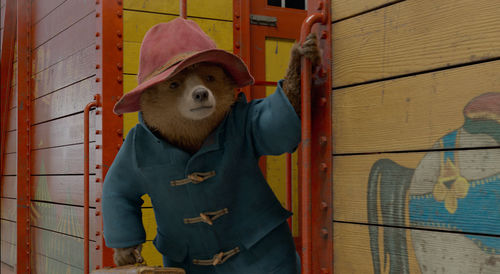Paddington Bear hangs from a train car
