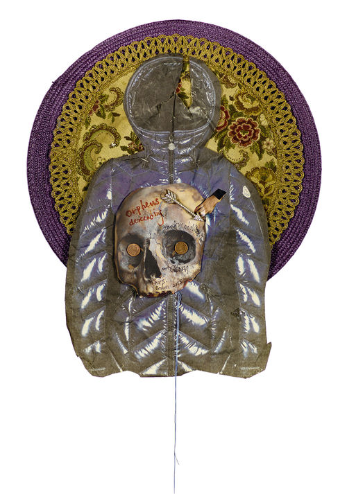A hooded puffer coat with a skull on the front, over an ornate, round weaving