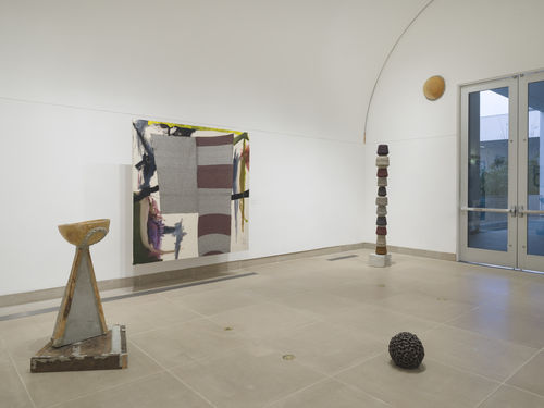 Installation image of multimedia paintings and sculptures installed in vault gallery