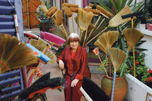The filmmaker Agnès Varda surrounded by brooms