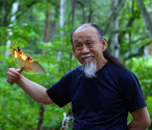 Photo of Sung Neung Kyung holding a flaming fan
