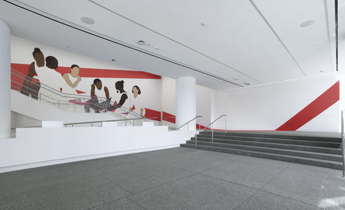 Hammer lobby wall installation depicting a group of abstracted figures, young gymnasts in leotards and high buns, which red architectural lines painted on white