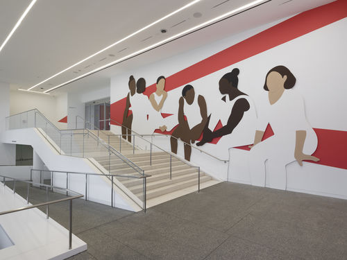 Hammer lobby wall installation depicting a group of abstracted figures, young gymnasts in leotards and high buns, which red architectural lines painted on white