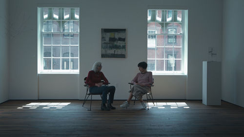 Artists Sylvia Palacios Whitman and Lenora de Barros sitting next to one another