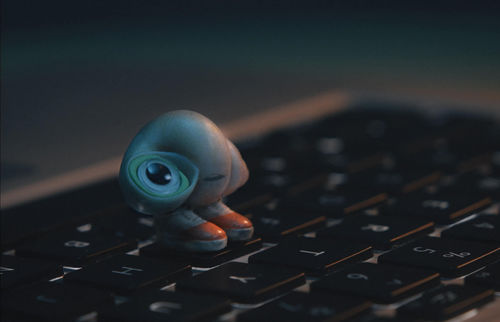 An anthropomorphized shell stands on a laptop keyboard