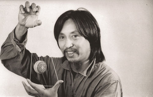 A man does a yo-yo trick for the camera