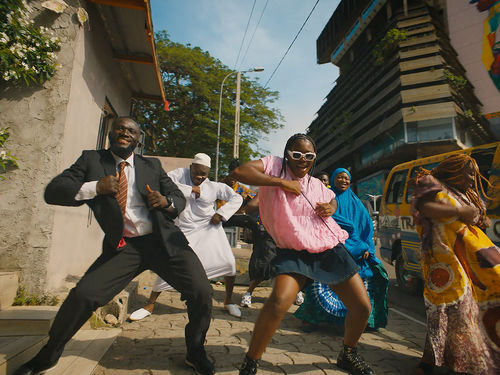A group of people dancing on a city street
