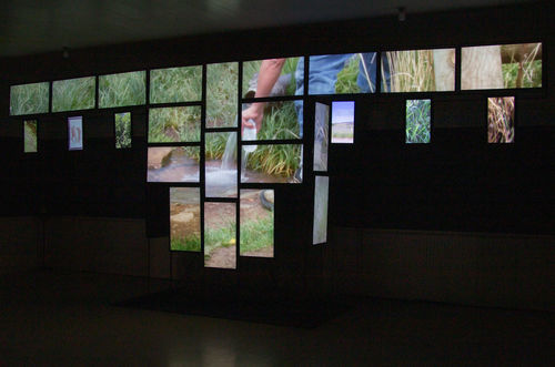 Installation of video screens in the shape of a Native American war shirt