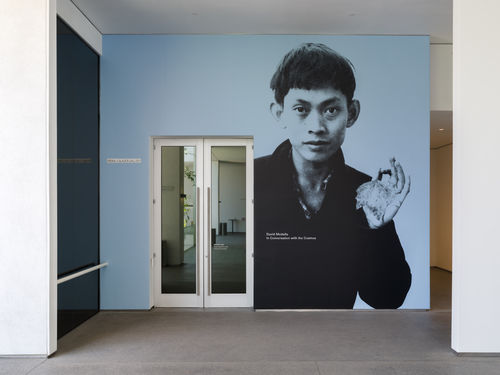 Exterior gallery wall with a photo of David Medalla