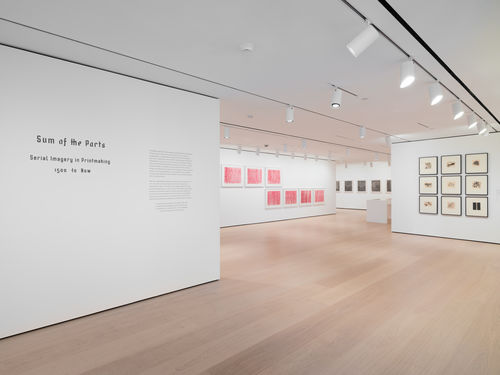 installation image of works on paper framed on walls