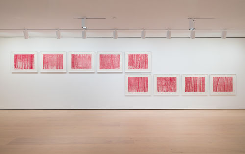 installation image of works on paper framed on walls