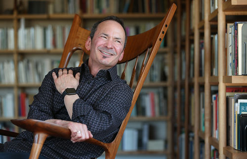 Forrest Gander, sitting in a rocking chair