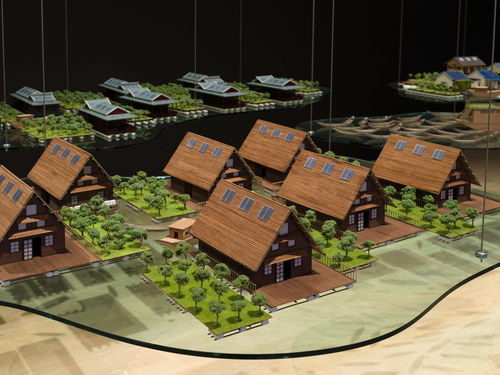 Sculpture of a grouping of identical houses, suspended from above