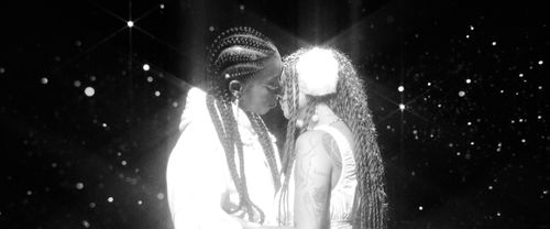 Two people kissing against a starry background