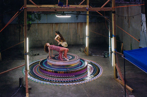 Two figures posing on a photoshoot or film set